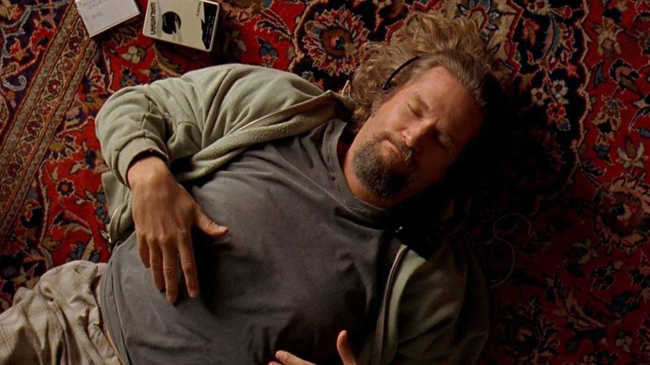 Jeff Bridges laying on the floor with headphones